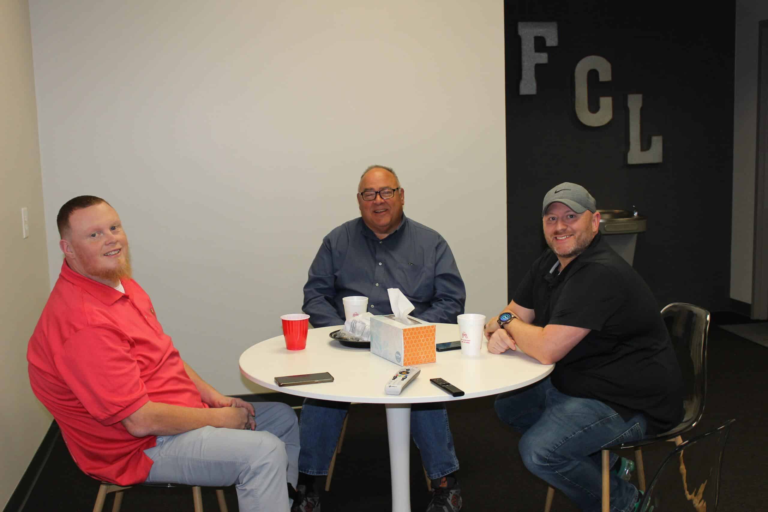 First Call Employees, David, Chuck, and Chris, finishing lunch in the breakroom.