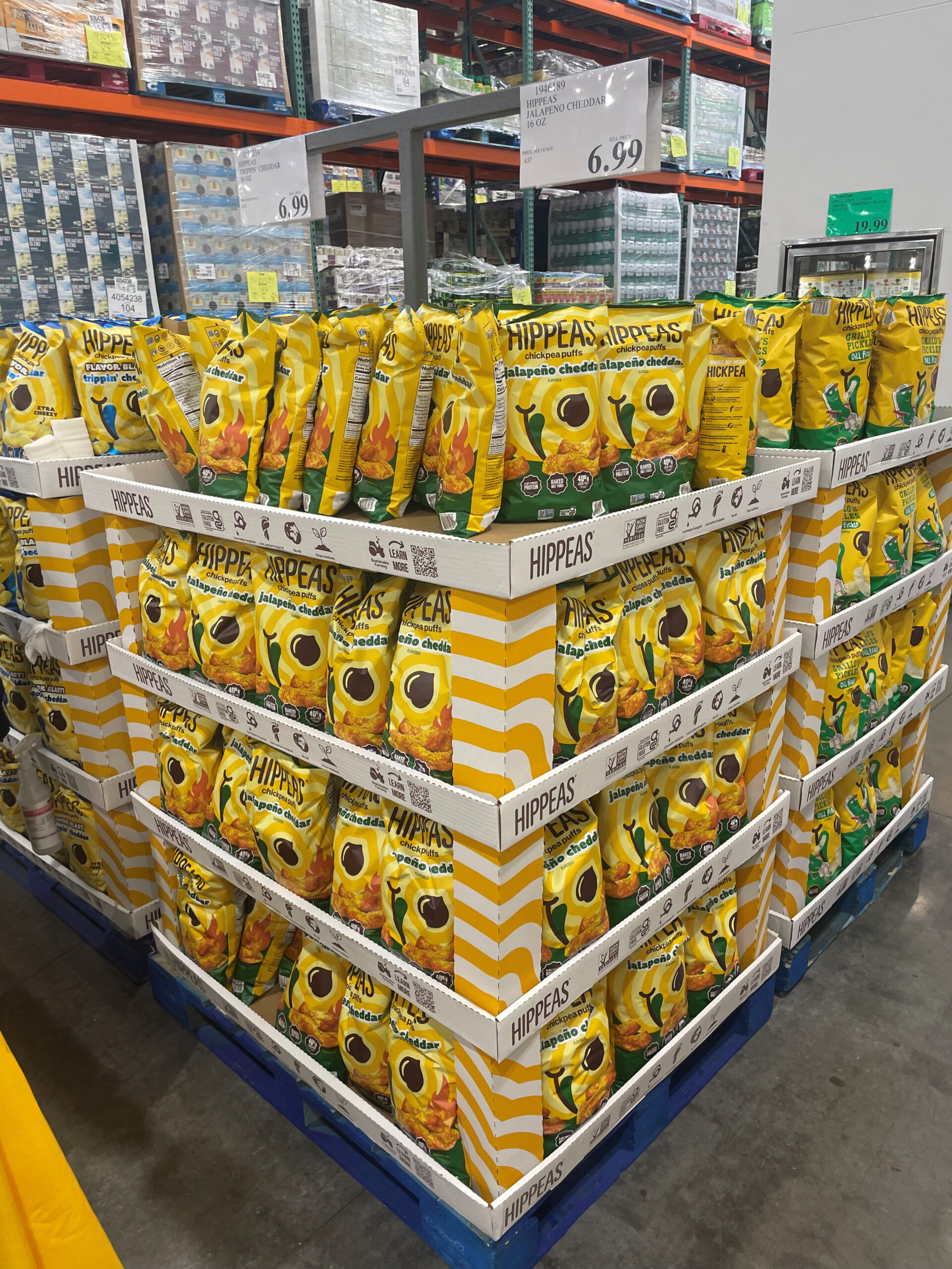 Palletized HIPPEAS snack display stocked with multiple flavors inside a Costco warehouse.