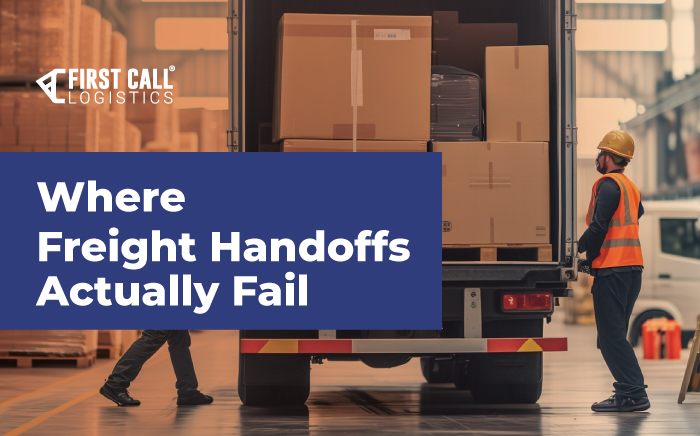 Workers loading palletized freight into a truck at a warehouse loading dock